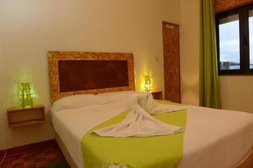 a bedroom with a bed with a towel on it at SEIA Apartamentos Serra da Estrela in Seia