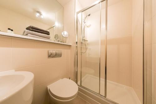 a bathroom with a shower and a toilet and a sink at THE BROCH, Ground Floor City Centre Apartment, sleeps 6 in Perth