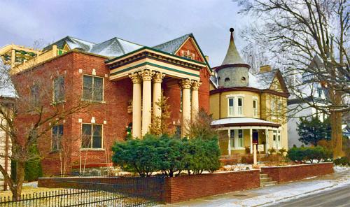 a large red brick house with a turret at Lyndon House Bed & Breakfast in Lexington
