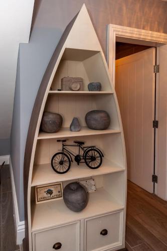 a book shelf with a bike inside of it at Ocean View,Kinsale, Hosted by Exquisite holiday homes, sleeps 22 in Kinsale