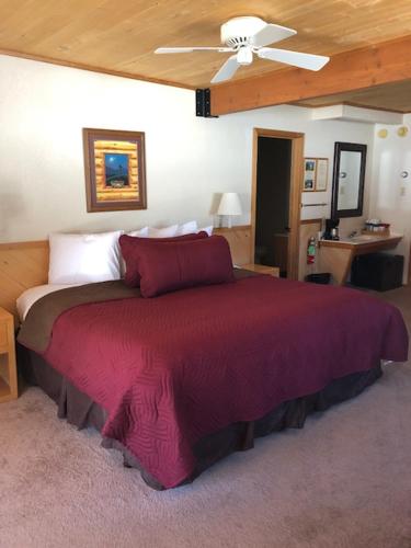 a bedroom with a large red bed with a ceiling at Sitzmark Sports Lodge in Red River