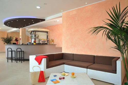 a living room with a couch and a table at Hotel Favorita in Cesenatico