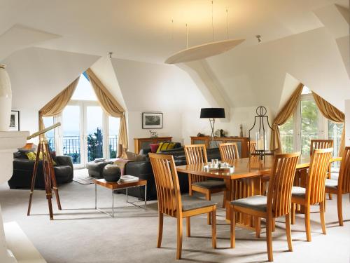 a living room with a table and chairs at Garryvoe Hotel in Ballycotton