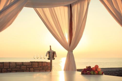a room with a table with grapes and wine glasses at Istrian Villas Plava Laguna in Umag