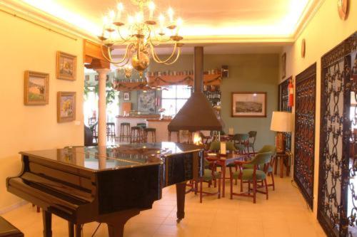 a living room with a piano and a dining room at Al Sur de Chipiona in Chipiona
