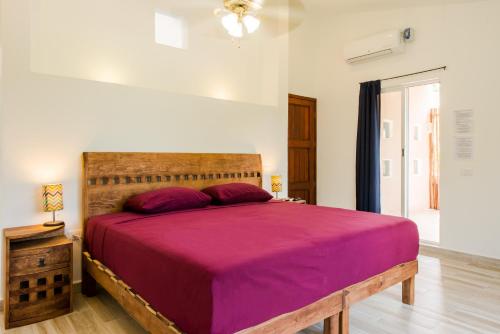 a bedroom with a bed and a dresser at Villas Picalu Studios & Suites in Puerto Aventuras