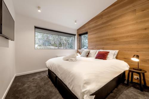 a bedroom with a large bed and a window at Elk at Falls in Falls Creek