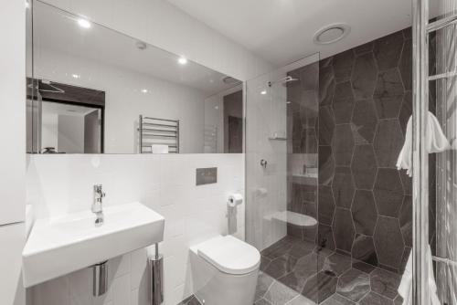 a bathroom with a toilet and a sink and a shower at Elk at Falls in Falls Creek