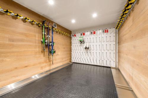 a walk in closet with wood paneled walls and ski racks at Elk at Falls in Falls Creek