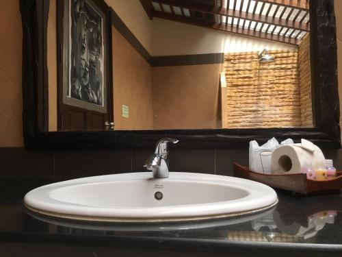 a sink in a bathroom with a mirror and towels at Grand Manita Beach Resort in Lamai