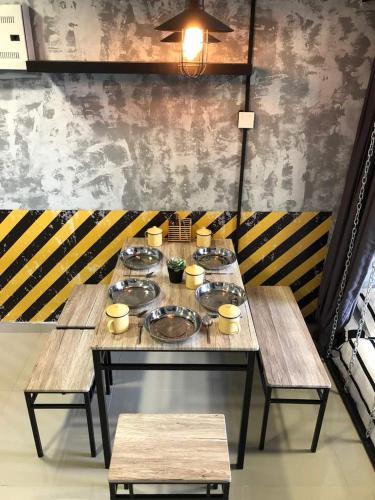 a table with plates and bowls on top of it at Escapade Prison Suites Petaling Jaya in Petaling Jaya