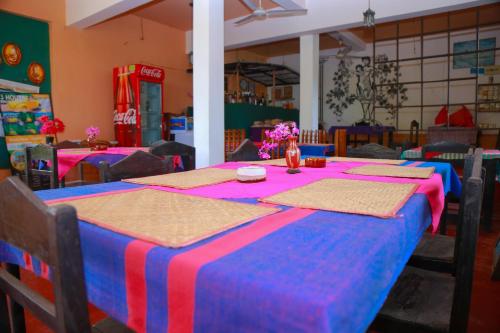 a table with a blue and red table cloth at Lucullus Garden in Bentota