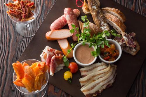 a black plate of food with different types of food at The Capitol Hotel Tokyu in Tokyo