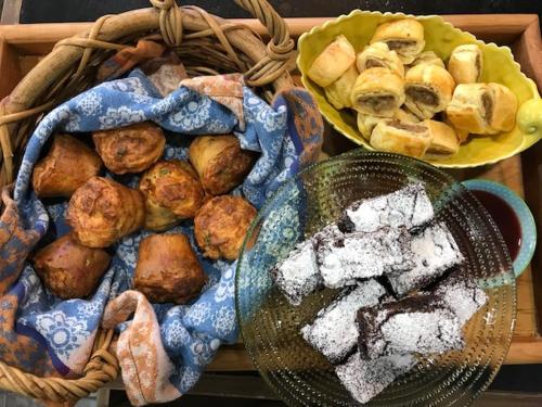 two baskets filled with different types of bread and pastries at Kauri Park Motel in Kerikeri