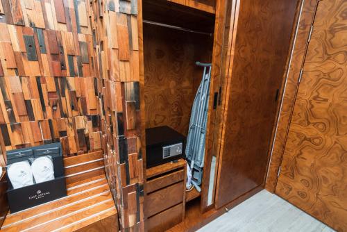 a small room with wooden walls and a door at East Astana Hotel in Astana