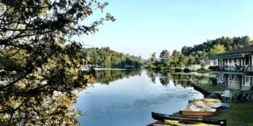 a view of a river with boats on it at Gauthier's Saranac Lake Inn in Saranac Lake