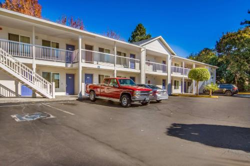 a red truck parked in front of a building at Motel 6 Portland Mall - 205 in Portland
