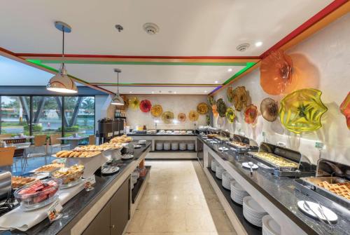 a buffet line in a restaurant with food on display at Wyndham Garden Guadalajara Expo Plaza del Sol in Guadalajara