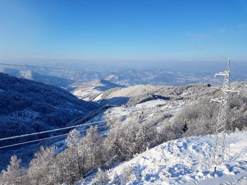 a snow covered mountain with a ski lift at Milmari M18 Kopaonik in Kopaonik