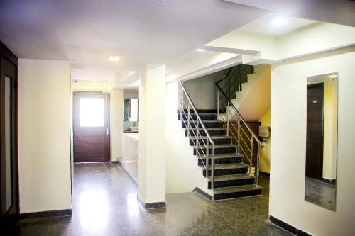 a hallway with a spiral staircase in a house at SKS Hospitality in Gurgaon