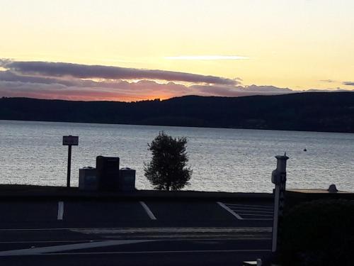 a view of a large body of water at sunset at Colonial Lodge Motel in Taupo