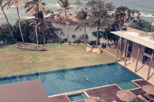 an aerial view of a swimming pool and the ocean at Le Grand Galle in Galle