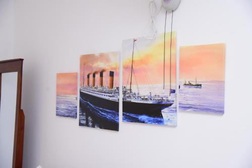 a painting of a boat in the ocean at White Villa Airport Transit Hotel in Katunayake