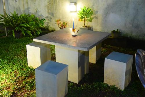 a concrete table with a candle on top of it at White Villa Airport Transit Hotel in Katunayake