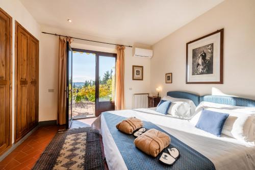 a bedroom with two beds with towels on them at Relais Vignale & Spa in Radda in Chianti