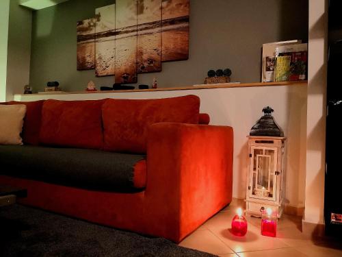 a red couch sitting in a living room with candles at Luxury Home in Spáta