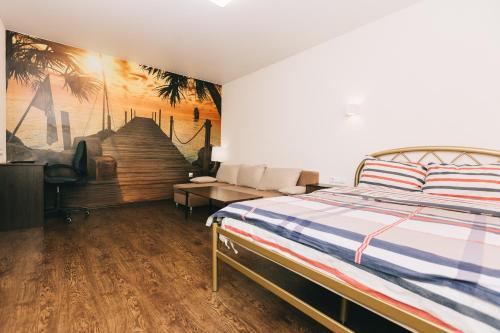 a bedroom with a bed and a painting on the wall at Apart-Hotel in Sumy