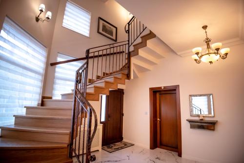 a staircase in a house with a chandelier at Ana Boutique in Alba Iulia