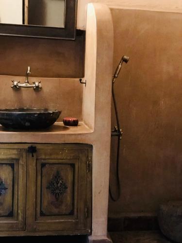 a bathroom with a sink and a shower at Les Jardins de Taja in Ourika