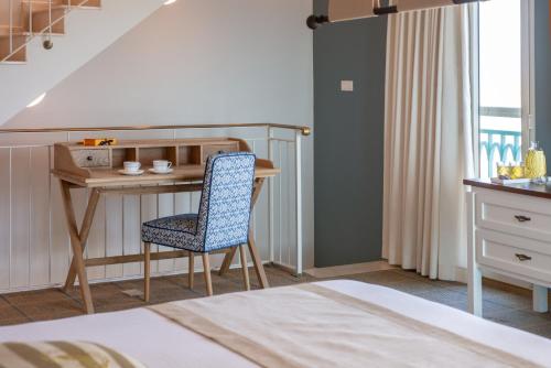 a bedroom with a desk and a chair and a bed at Herods Boutique Eilat a Premium collection by Fattal Hotels in Eilat