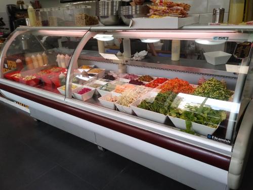 a display case filled with different types of food at Namaste in Tel Aviv
