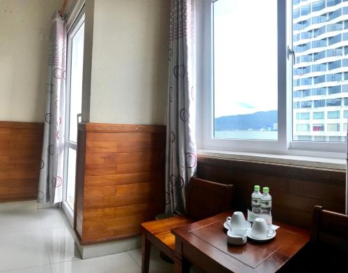 a dining room with a table and a window at Hoang Yen Canary Hotel in Quy Nhon