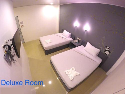 a room with two beds with white pillows at GC Suites in Cagayan de Oro