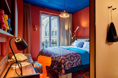 a bedroom with red walls and a bed with a blue ceiling at 25hours Hotel Terminus Nord in Paris