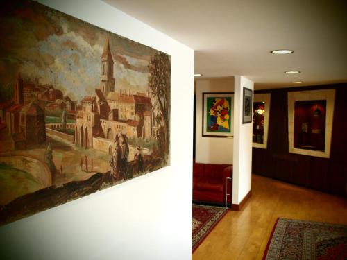 a painting hanging on a wall in a hallway at Hotel Perusia in Perugia