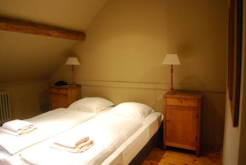 a bedroom with two beds with towels on them at Orshof in Oudsbergen 