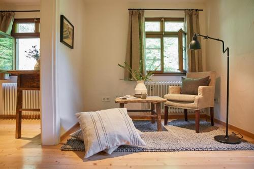 a living room with a chair and a lamp at Hotel & Restaurant Linde in Münstertal