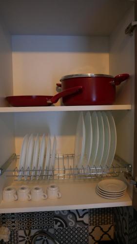 a kitchen shelf with plates and a pot on top at Evmelia Kakopetria Suites in Kakopetria