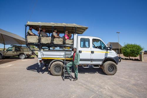 a group of people riding on the back of a truck at Lapa Lange Game Lodge in Mariental