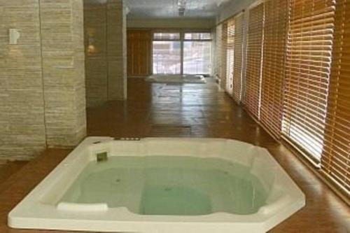 a large white bath tub in a room at Barra da Tijuca Resort Bora Bora in Rio de Janeiro