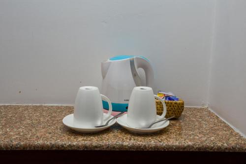 a white tea kettle sitting on top of a counter at Apsara Boutique Hotel in Kathmandu