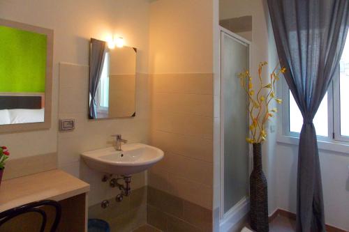 a bathroom with a sink and a mirror at Hotel Midtown Milano in Milan