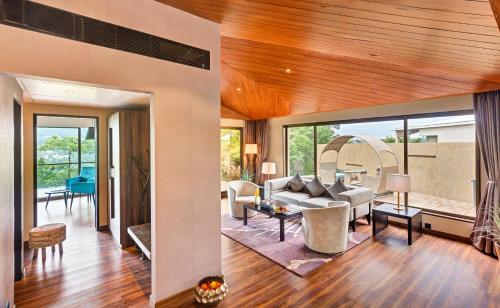 a living room with a couch and a table at Aamby Valley City in Lonavala