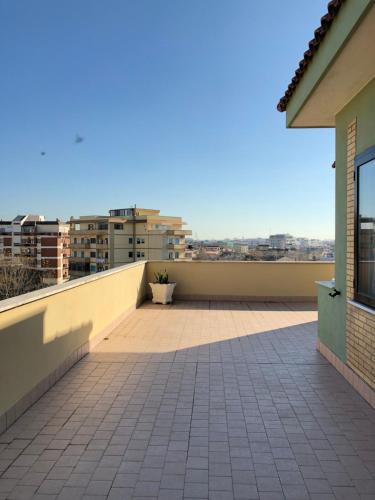 a balcony with a view of a city at Maison Lidia in Fiumicino