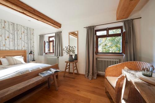 a bedroom with a bed and a chair and a window at Hotel & Restaurant Linde in Münstertal
