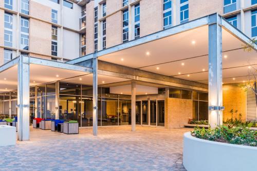 an external view of a building with large windows at ONOMO Hotel Durban in Durban
